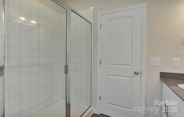 bathroom with vanity and a shower with shower door