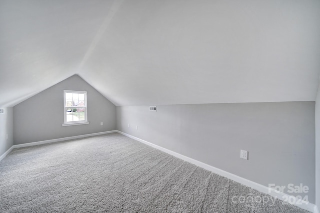 bonus room featuring carpet and vaulted ceiling