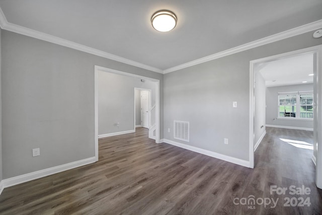 unfurnished room with dark hardwood / wood-style flooring and crown molding