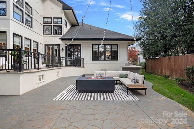 view of patio / terrace with an outdoor living space with a fire pit