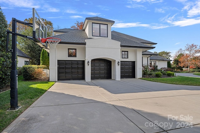 view of front of property with a garage and a front yard