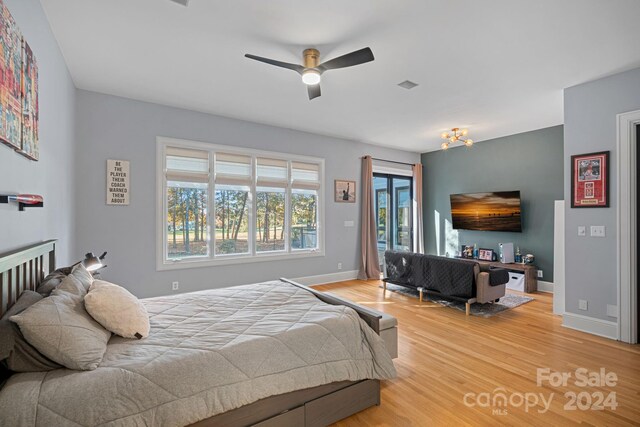 bedroom with hardwood / wood-style floors and ceiling fan