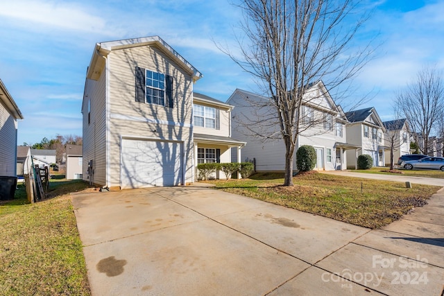 view of front of home with a garage and a front lawn