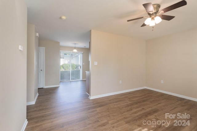 unfurnished room with ceiling fan and dark hardwood / wood-style floors