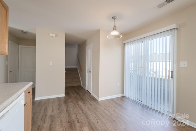 unfurnished dining area featuring light hardwood / wood-style floors