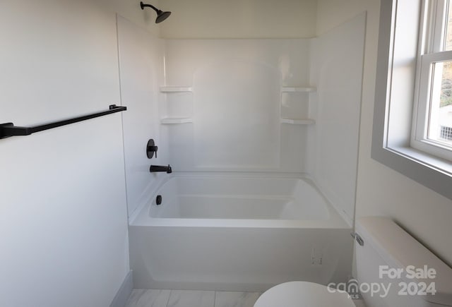 bathroom with toilet and tub / shower combination