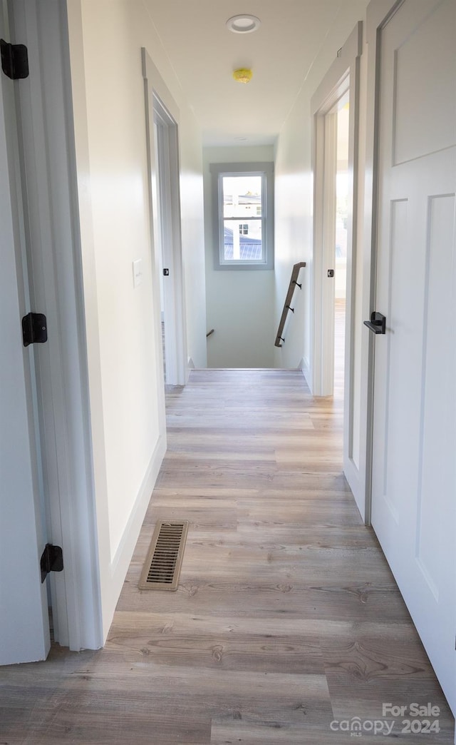 hall with light hardwood / wood-style flooring