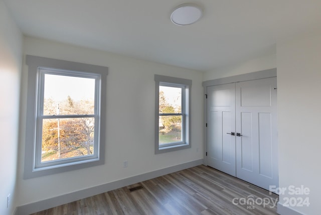 unfurnished bedroom featuring a closet and light hardwood / wood-style floors