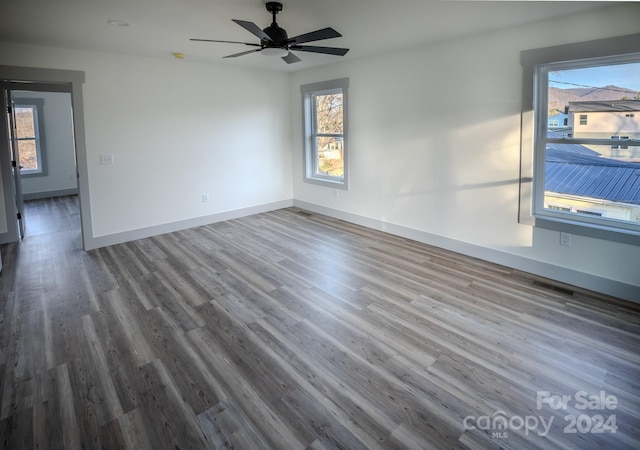 empty room featuring hardwood / wood-style floors and ceiling fan