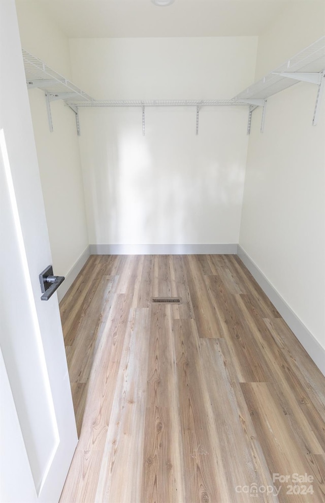 walk in closet featuring light hardwood / wood-style floors