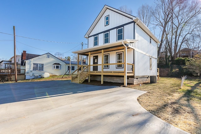 view of front of property with a porch and central AC