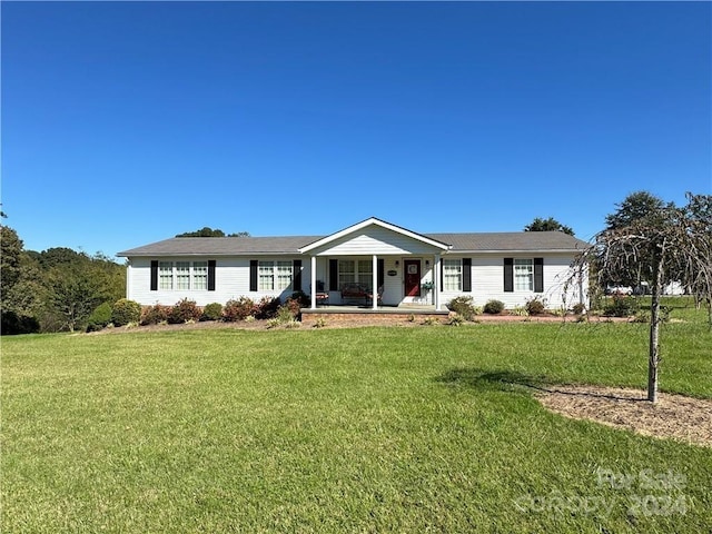 ranch-style home with a front lawn and covered porch