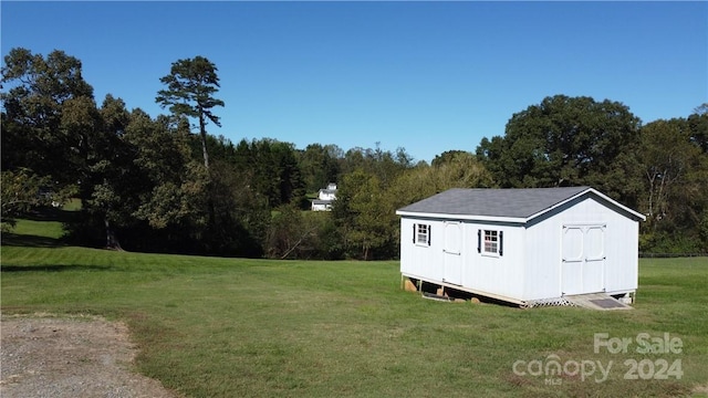 view of outbuilding featuring a yard