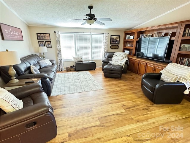 living room featuring a textured ceiling, light hardwood / wood-style floors, ceiling fan, and ornamental molding