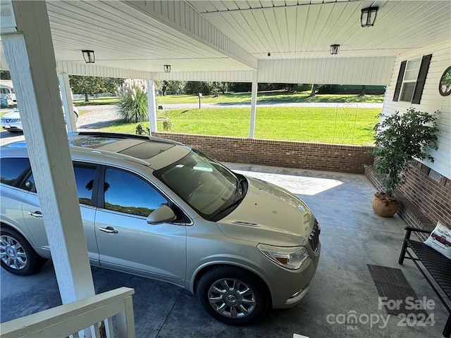 view of parking featuring a lawn and a carport