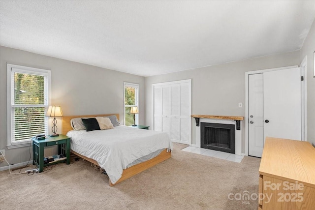 bedroom with light carpet and two closets