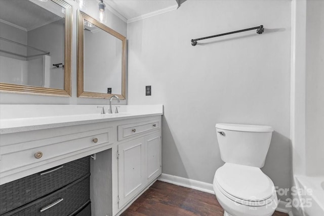 bathroom with vanity, ornamental molding, hardwood / wood-style floors, and toilet