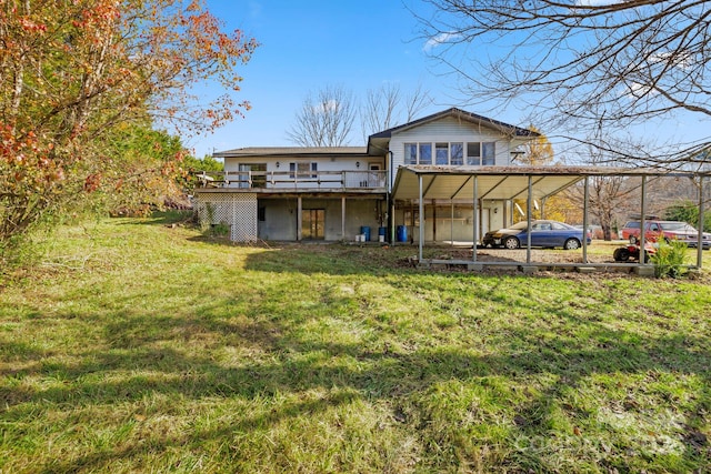 back of property with a wooden deck and a yard