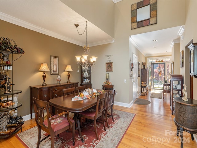 dining area featuring a chandelier, light hardwood / wood-style floors, and ornamental molding