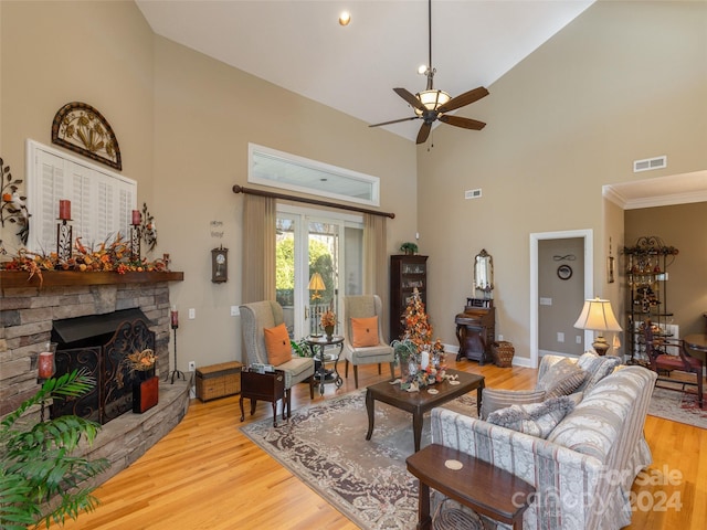 living room with ceiling fan, light hardwood / wood-style flooring, high vaulted ceiling, and ornamental molding