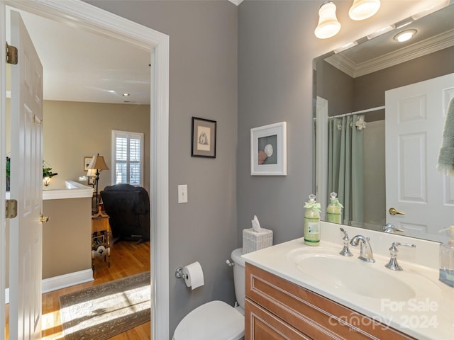 bathroom with vanity, crown molding, vaulted ceiling, toilet, and wood-type flooring