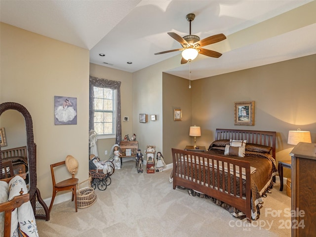 bedroom featuring ceiling fan and light carpet