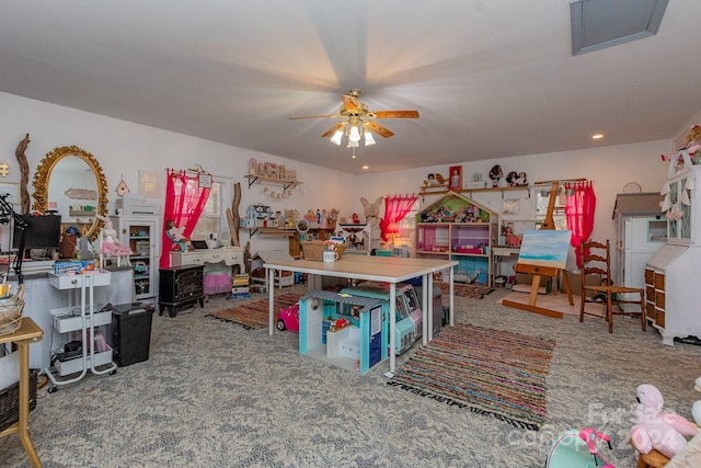 playroom featuring ceiling fan and carpet floors