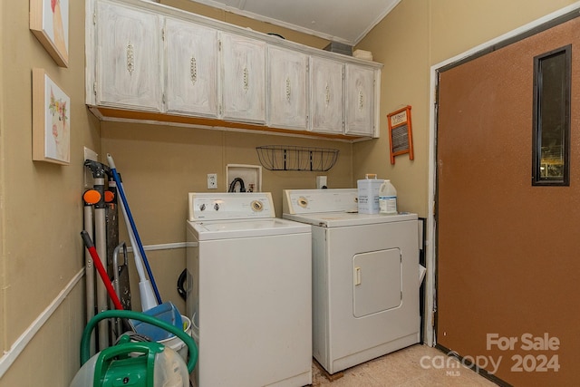 washroom featuring cabinets, ornamental molding, and washing machine and clothes dryer