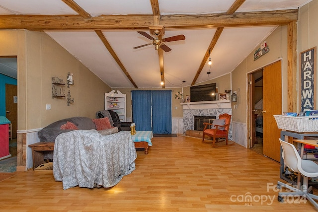 living room with beam ceiling, a fireplace, and hardwood / wood-style floors