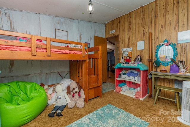 carpeted bedroom with wood walls