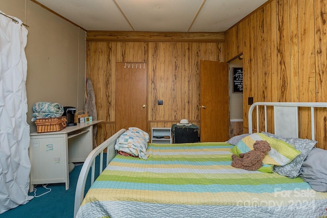 carpeted bedroom with wooden walls