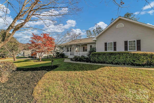 view of front of property with a front yard and a porch