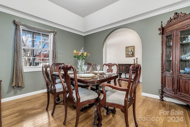 dining room with a textured ceiling and light hardwood / wood-style flooring