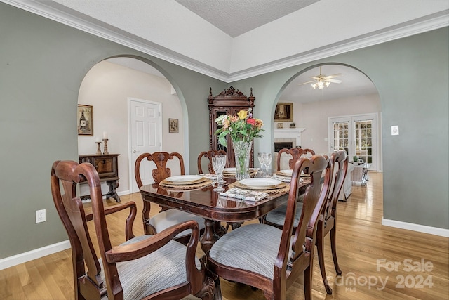 dining room featuring ceiling fan, crown molding, a textured ceiling, and light hardwood / wood-style flooring