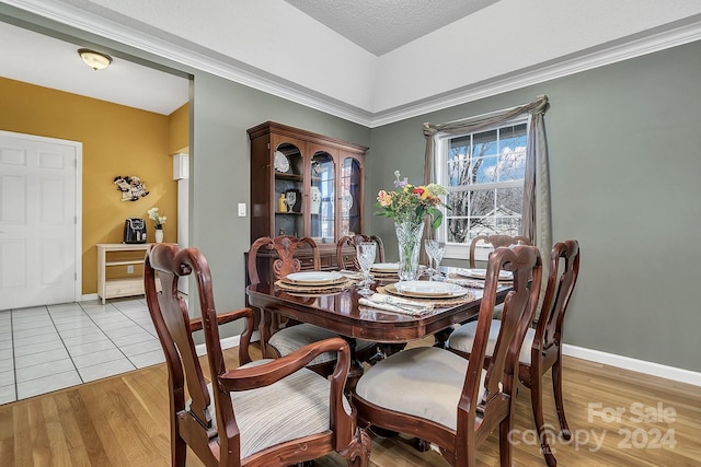 dining area with a textured ceiling and light wood-type flooring