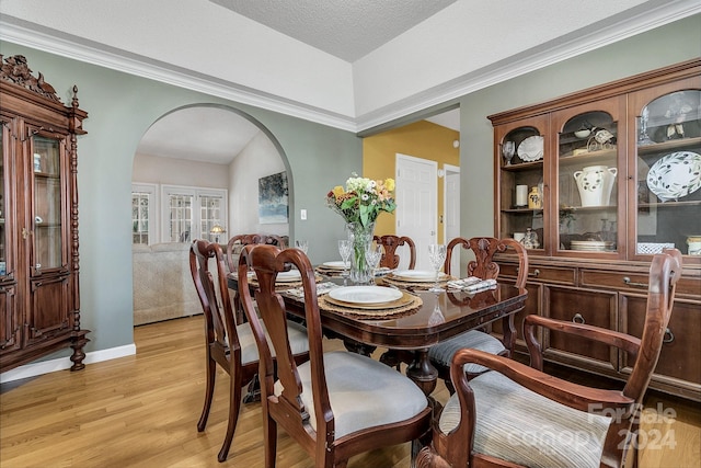 dining room featuring a textured ceiling and light hardwood / wood-style flooring