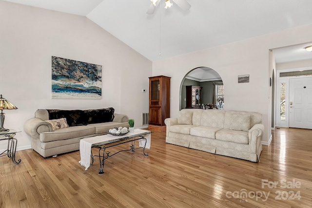 living room featuring ceiling fan, light hardwood / wood-style floors, and lofted ceiling