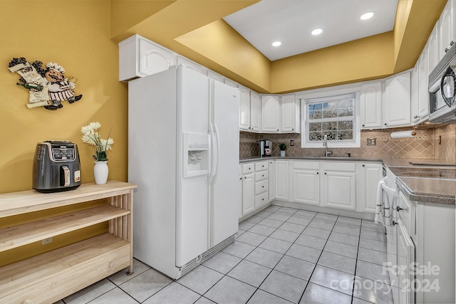 kitchen featuring white cabinetry, white appliances, sink, and light tile patterned floors