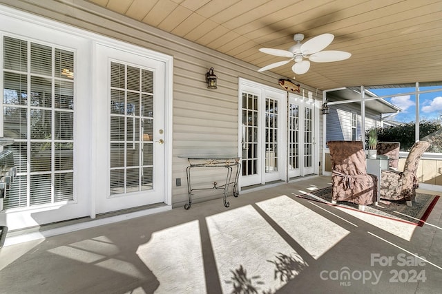 sunroom / solarium with ceiling fan and wood ceiling