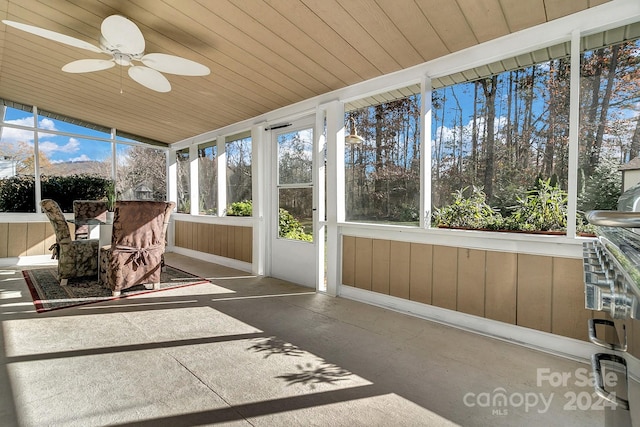 sunroom featuring ceiling fan and wood ceiling