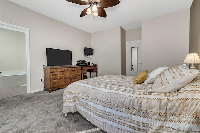 bedroom with connected bathroom, light colored carpet, and ceiling fan