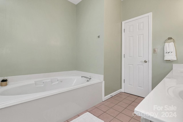 bathroom featuring tile patterned floors, a bathing tub, and vanity