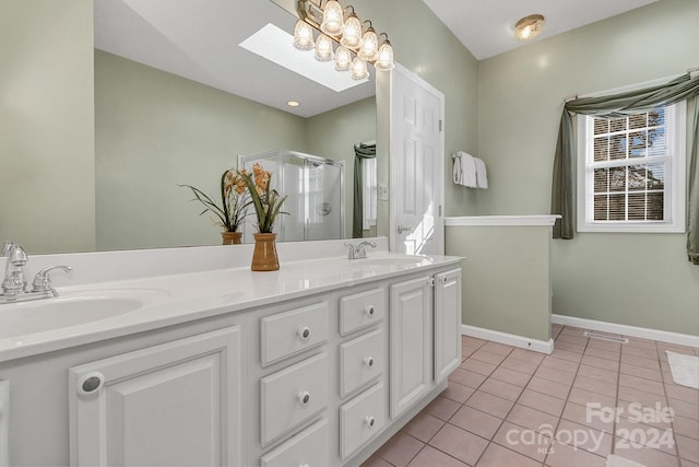 bathroom featuring tile patterned floors, vanity, walk in shower, and a skylight