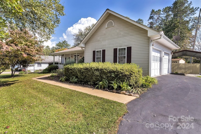 view of side of home with a lawn and a garage