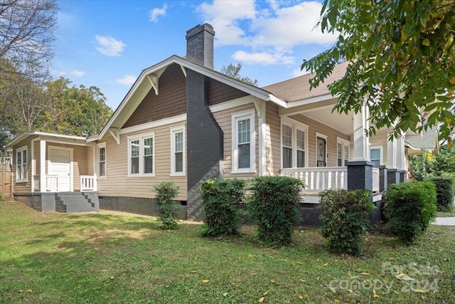 view of side of home with a lawn