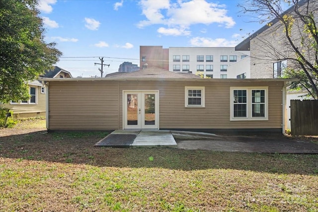 back of house with a lawn, a patio area, and french doors