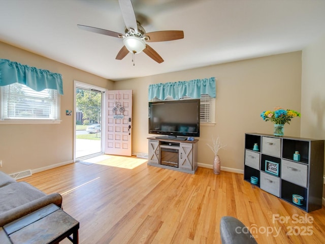 living room featuring ceiling fan and wood-type flooring