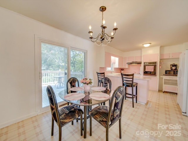 dining space with a notable chandelier