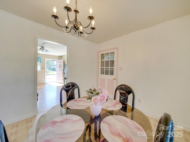 dining room with ceiling fan with notable chandelier and light wood-type flooring