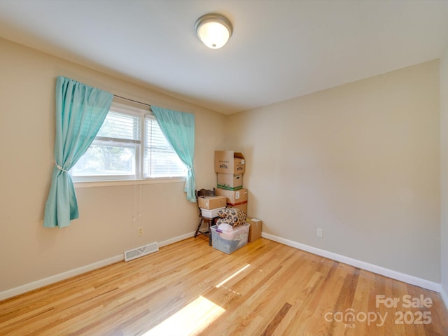 spare room featuring hardwood / wood-style flooring